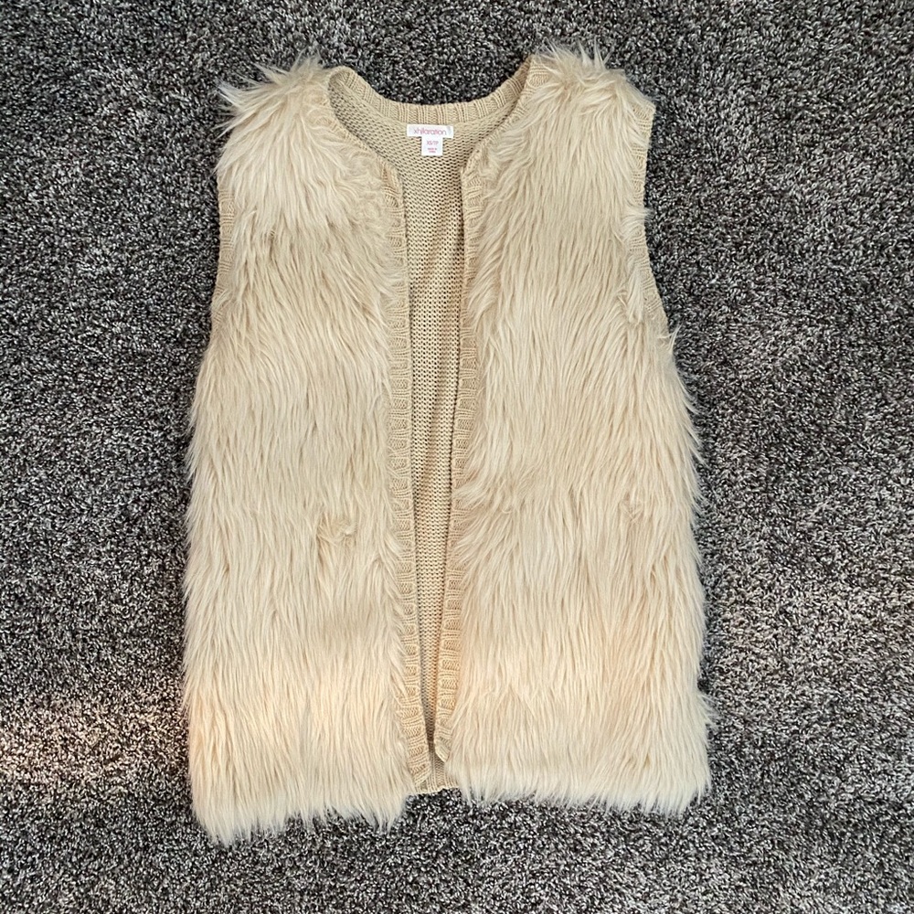 Cream colored fur vest.